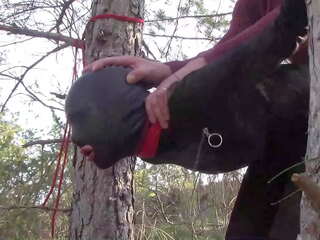 Tied up to a tree outdoor on voluptuous clothes&comma; wearing pantyhose and high ankle boots heels&comma; rough fuck